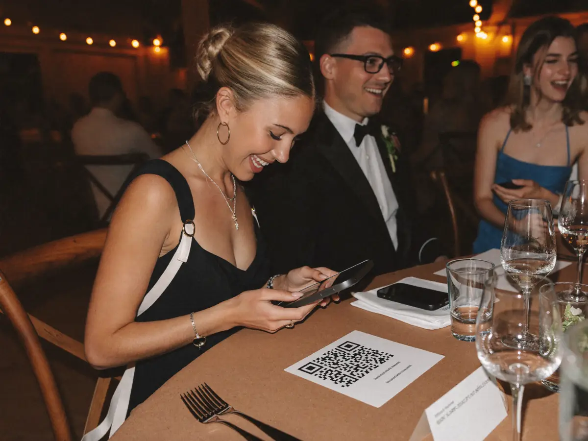 A wedding guest scanning a QR card on the table