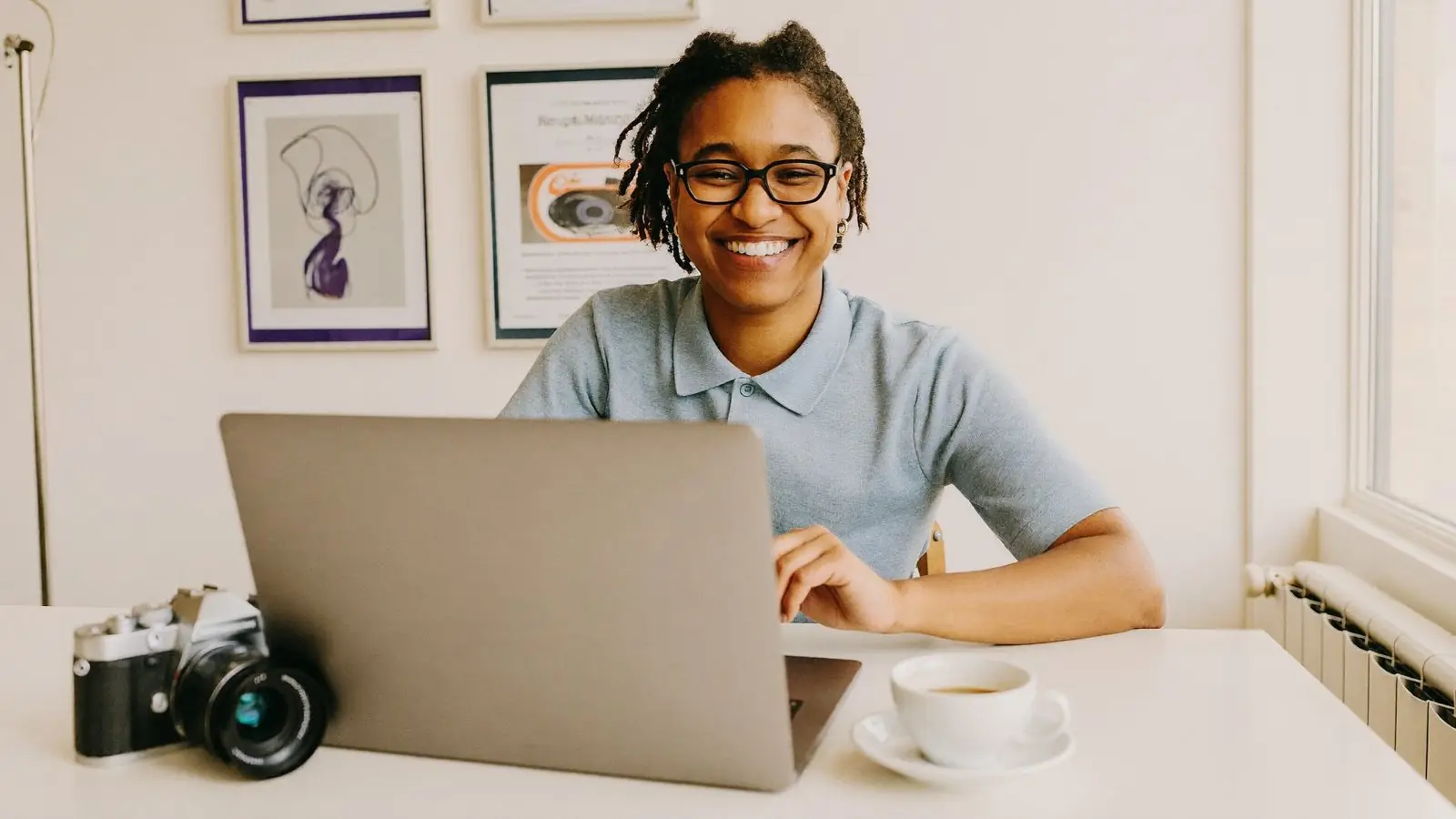 A studio owner smiling at her laptop