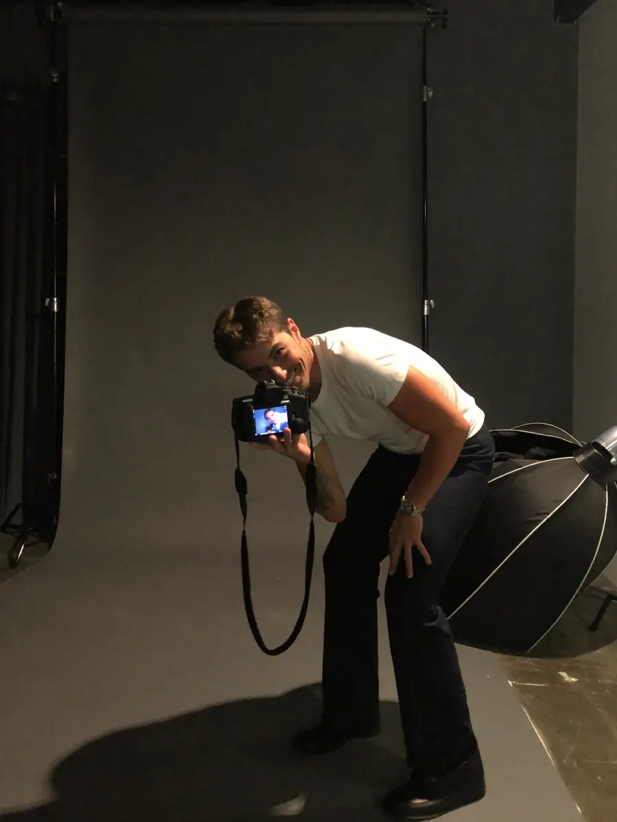 A portrait photographer at work in a studio