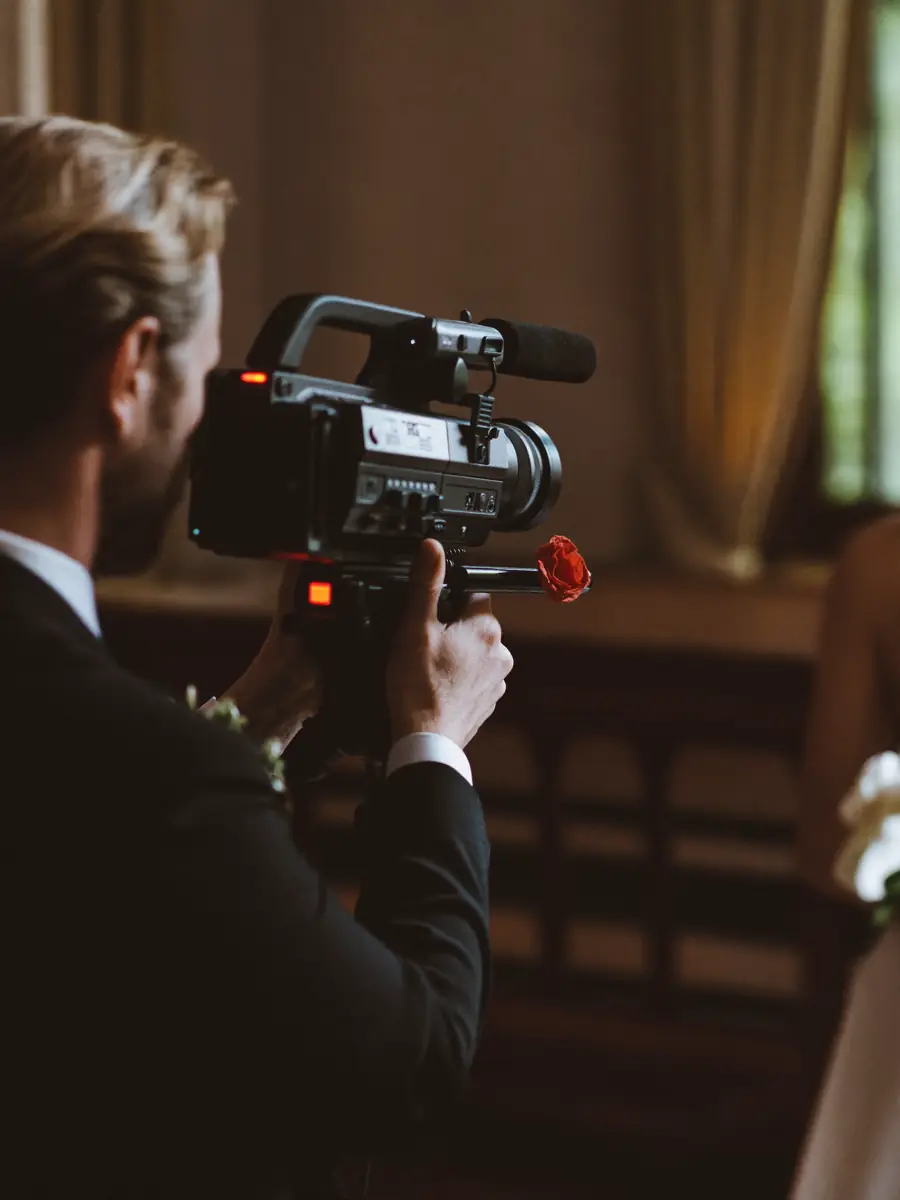 A videographer filming a wedding ceremony